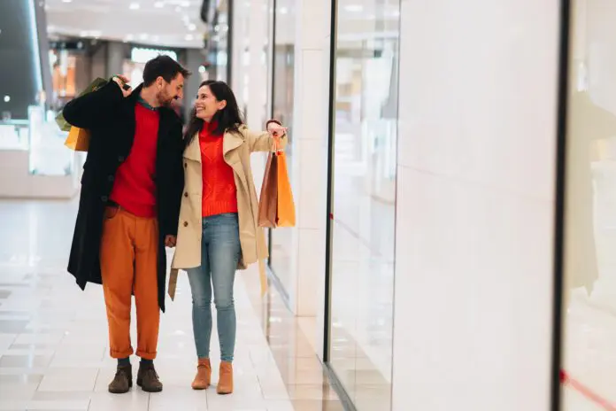 Romantic couple looking at each other while walking through a shopping mall