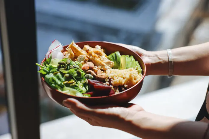 Holding a bowl of chicken salad