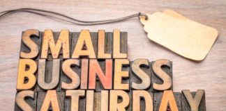Wooden, rustic sign saying, "Small business Saturday," for downtown McAllen stores.