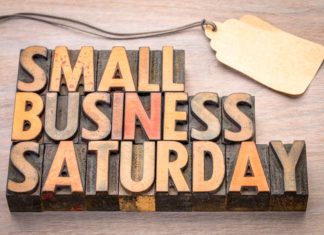 Wooden, rustic sign saying, "Small business Saturday," for downtown McAllen stores.