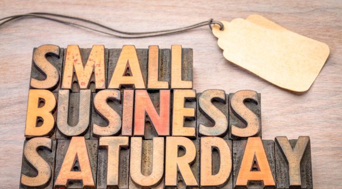 Wooden, rustic sign saying, "Small business Saturday," for downtown McAllen stores.