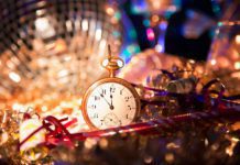 Small gold pocket watch surrounded by disco ball and tinsel at the las tiendas fun places in McAllen.