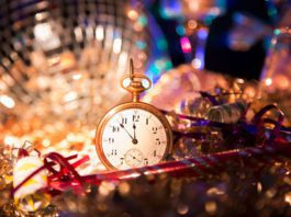 Small gold pocket watch surrounded by disco ball and tinsel at the las tiendas fun places in McAllen.