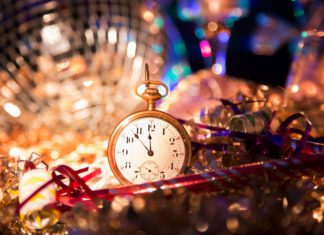 Small gold pocket watch surrounded by disco ball and tinsel at the las tiendas fun places in McAllen.