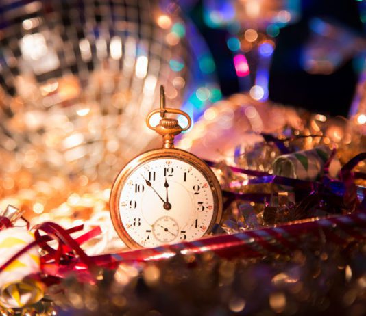 Small gold pocket watch surrounded by disco ball and tinsel at the las tiendas fun places in McAllen.