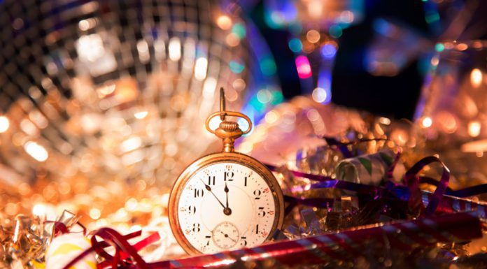 Small gold pocket watch surrounded by disco ball and tinsel at the las tiendas fun places in McAllen.