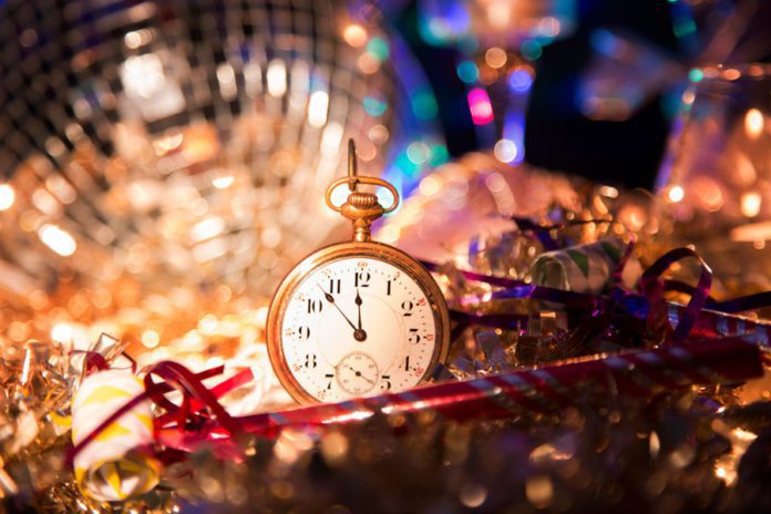 Small gold pocket watch surrounded by disco ball and tinsel at the las tiendas fun places in McAllen.