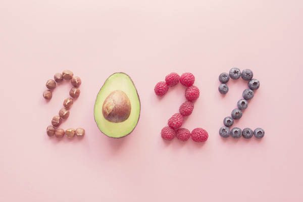 2022 made from healthy food on pink background, Happy New year, health diet resolution, goals and lifestyle