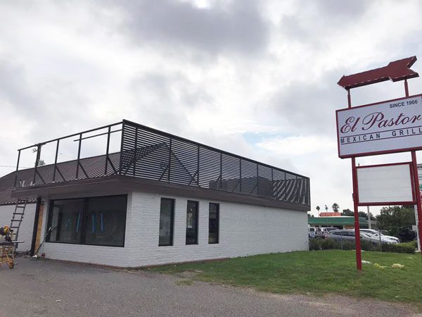 One of the new McAllen restaurants opening up soon is currently under construction with a white building and a red and white sign that reads ‘El Pastor Mexican Grill.’