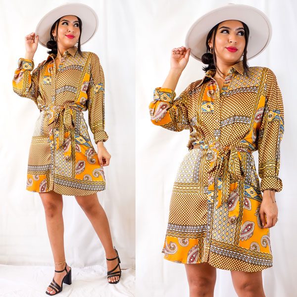 woman in yellow dress posing in front of McAllen stores